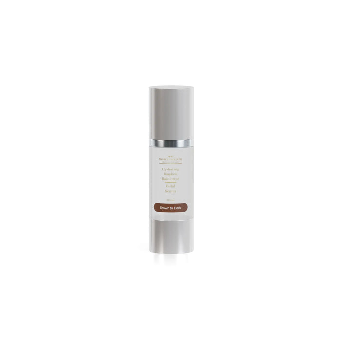 A single Wagner MacKenzie Skincare Hydrating Bamboo Rainforest Facial Serum is showcased. The packaging features a silver cylindrical bottle with a pump dispenser. The label specifies the formulation for “Brown to Dark” skin tones, with a dark brown background and gold text, maintaining the brand’s elegant and minimalistic design