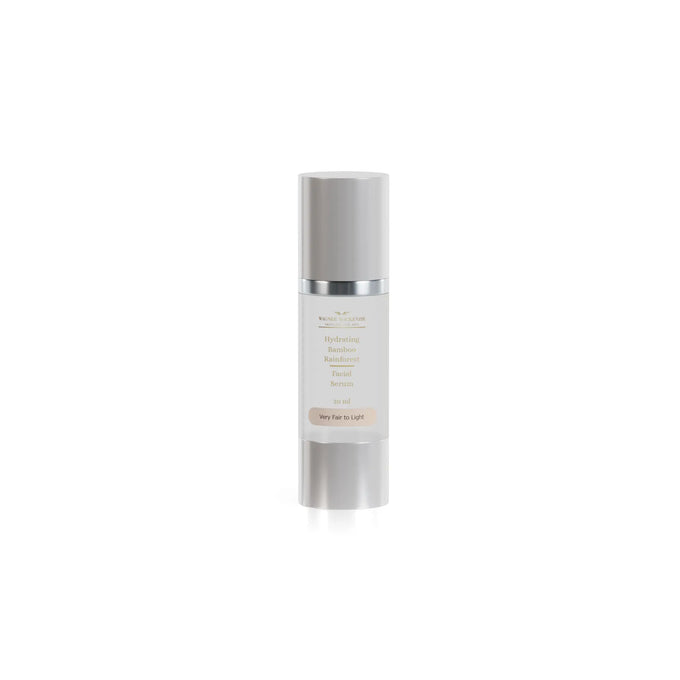  A single Wagner MacKenzie Skincare Hydrating Bamboo Rainforest Facial Serum is showcased. The packaging features a silver cylindrical bottle with a pump dispenser. The label specifies the formulation for “Very Fair to Light” skin tones, with a soft beige background and gold text, maintaining the brand’s elegant and minimalistic design.